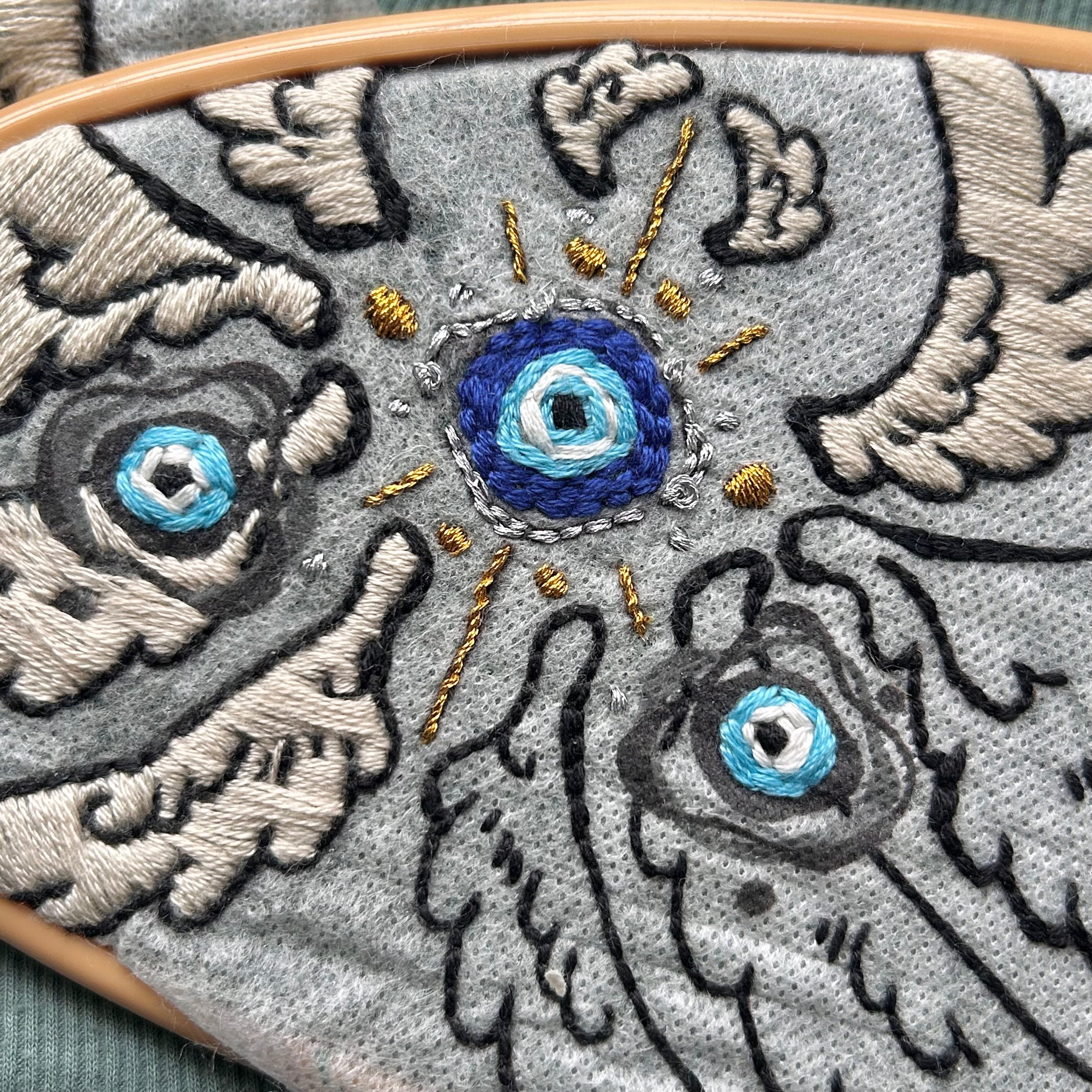 A hooped evil eye with wings