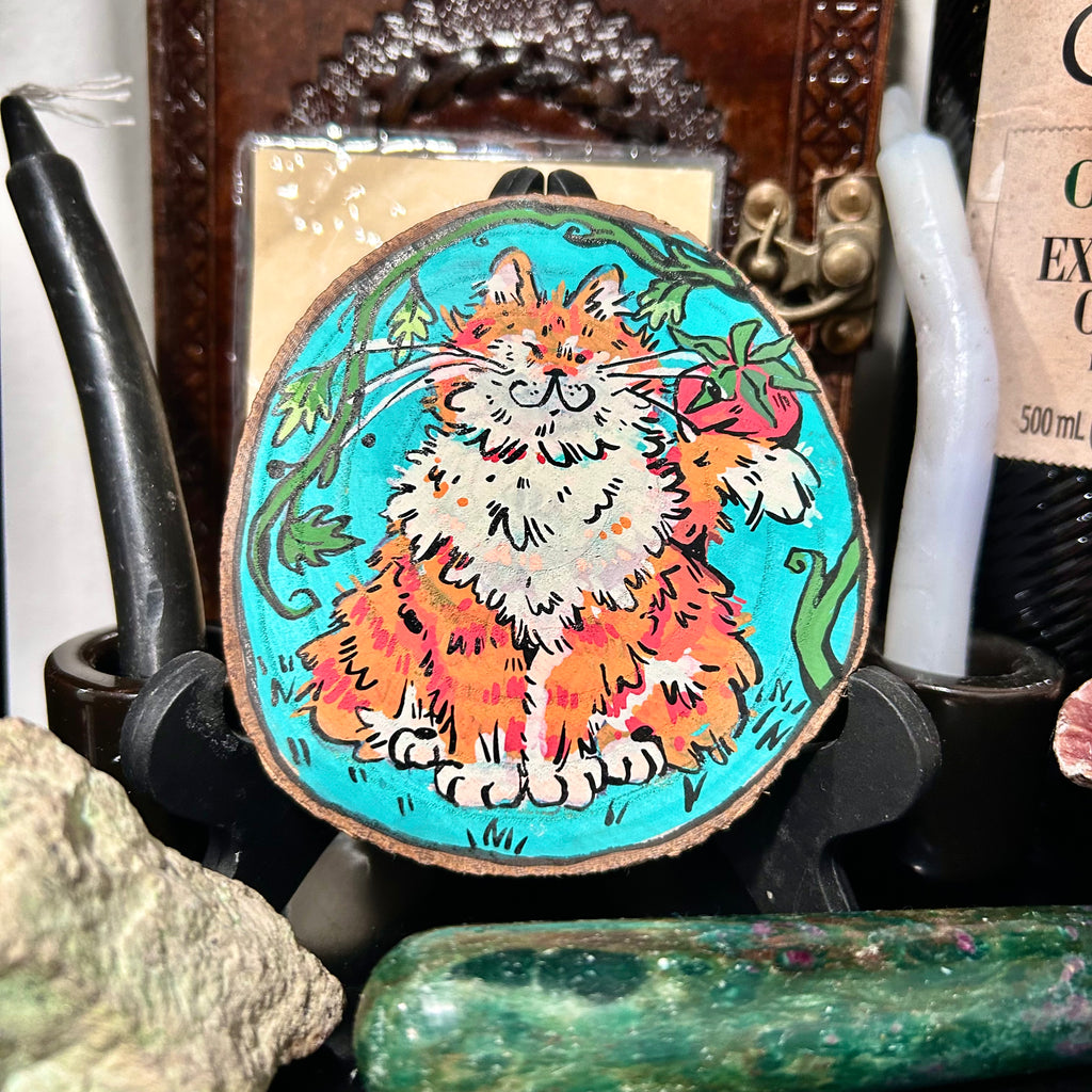 colorful acrylic painting of a fully orange tabby holding a tomato decorative coaster