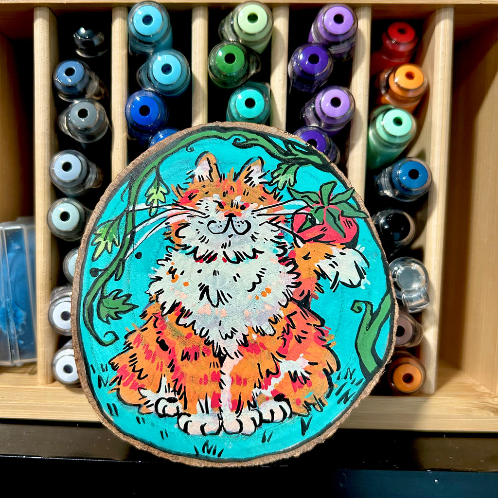 colorful acrylic painting of a fully orange tabby holding a tomato decorative coaster